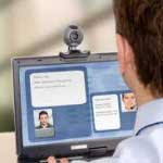 A man chatting with another person online via computer