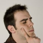 A man close his eyes and think hard