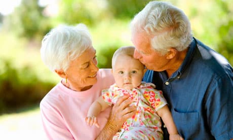 Senior couple holding baby