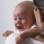 A birth mother comforts andother birth mothers baby