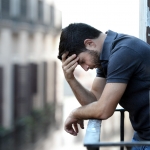 Man with depression: SAD and lonely.