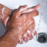 A man washing his hands.