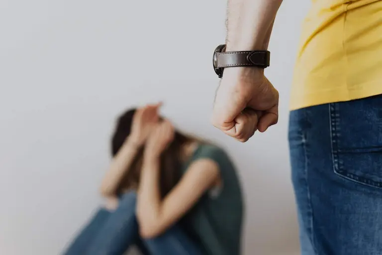 A woman is being physically abused by her husband.