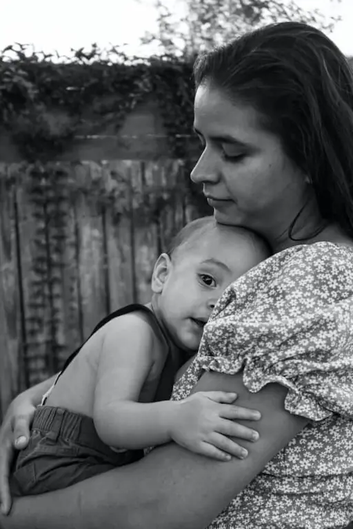A mother holding her baby feeling blue.