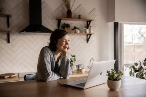 A woman having an online counselling session via a laptop.